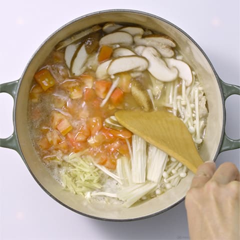 豚肉に火が通ったら、【A】とトマト、えのき、しいたけ、しょうがを入れ中火で3～4分煮る。